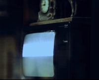 an old tv with a clock on it